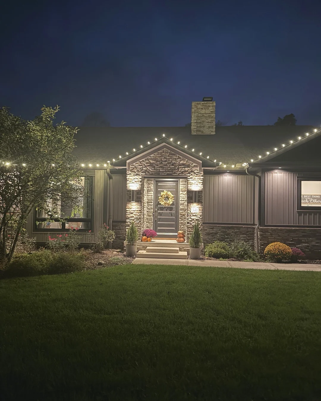 Christmas lighting installed around a covered porch by Summit Wash.